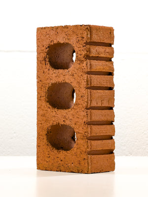 Angled shot of Lazy Brick sculpture, parodying AI-generated artistic rationale in minimalist form