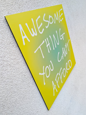 side view of 'Awesome Thing You CAn't Afford' - an aluminium Dibon word artwork that challenges Black Friday and consumer culture